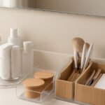 Modern bathroom shelf with acrylic trays, rotating organizer, and minimal decor elements Shower corner organizer filled with shampoo bottles, loofah, and razors—stylish and functional Before-and-after bathroom counter showing clutter transformed using Amazon organizers